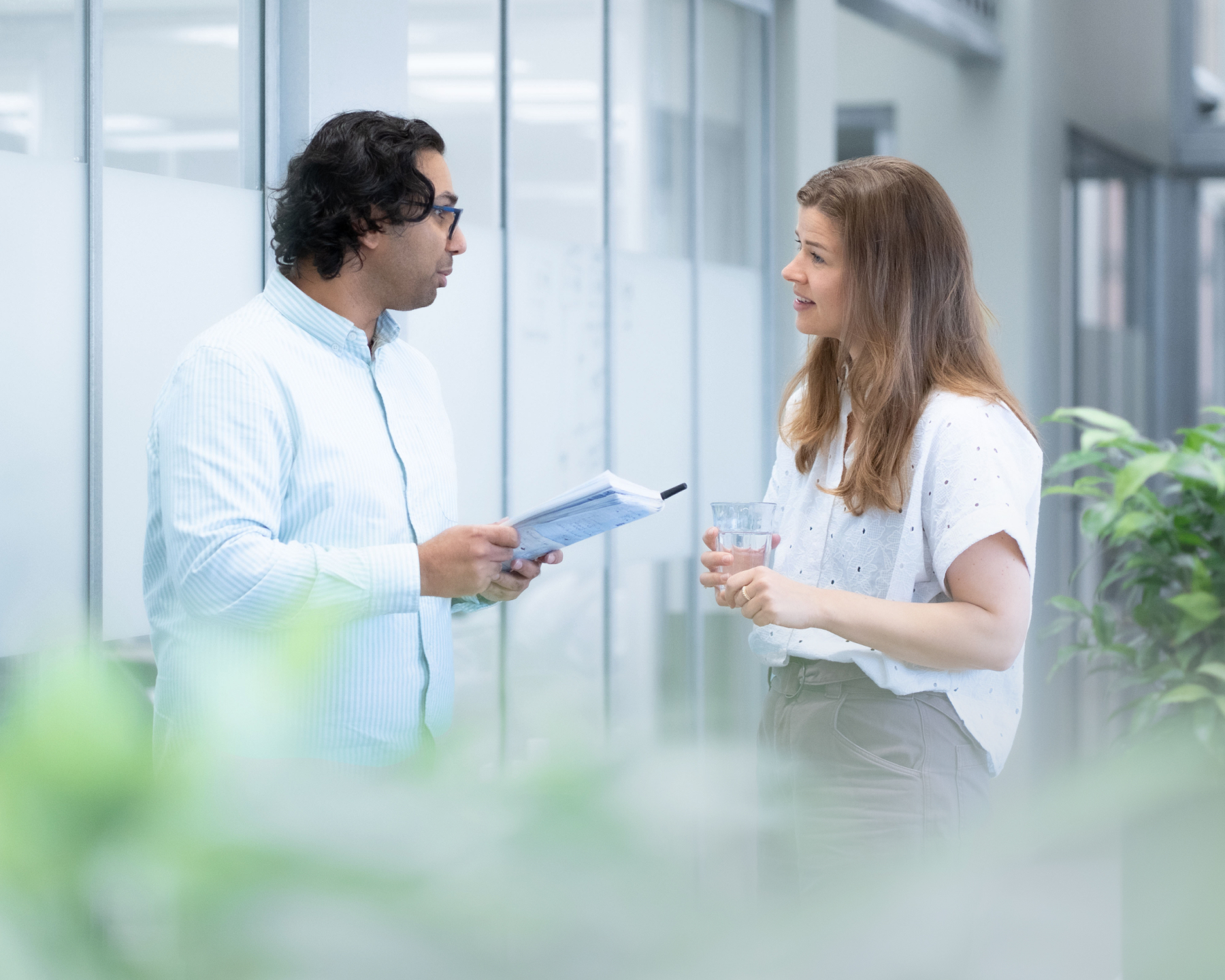 Two Steel CleanUp colleagues discussing process data in the office